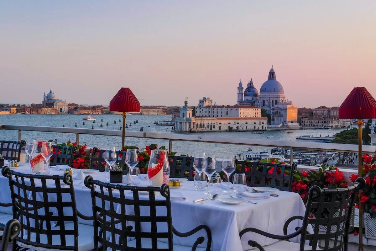 Rooftop dining terrace above Venice at dusk
